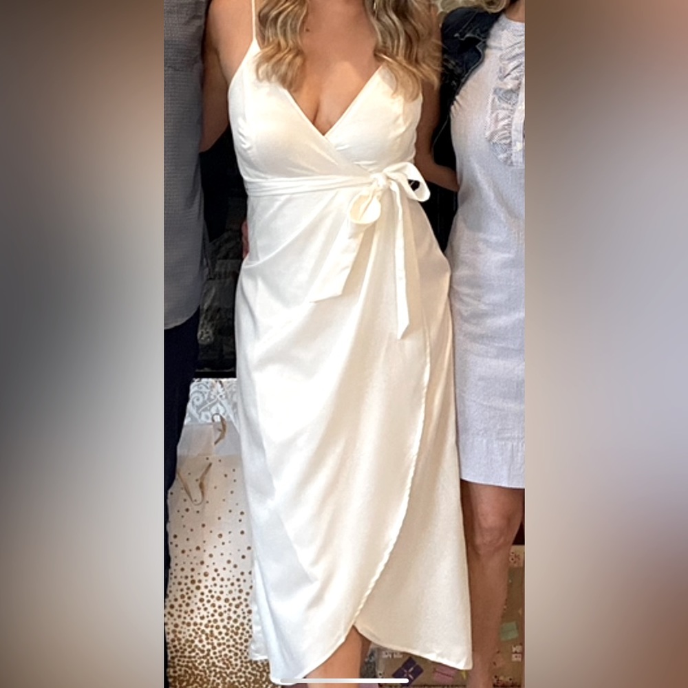 Flattering white dress with waist tie, tulip hem. Perfect for brides!